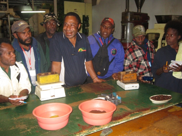 Arabicas Ltd caretaker Manager Lawrence Binap explaining coffee roasting process to the visitors.